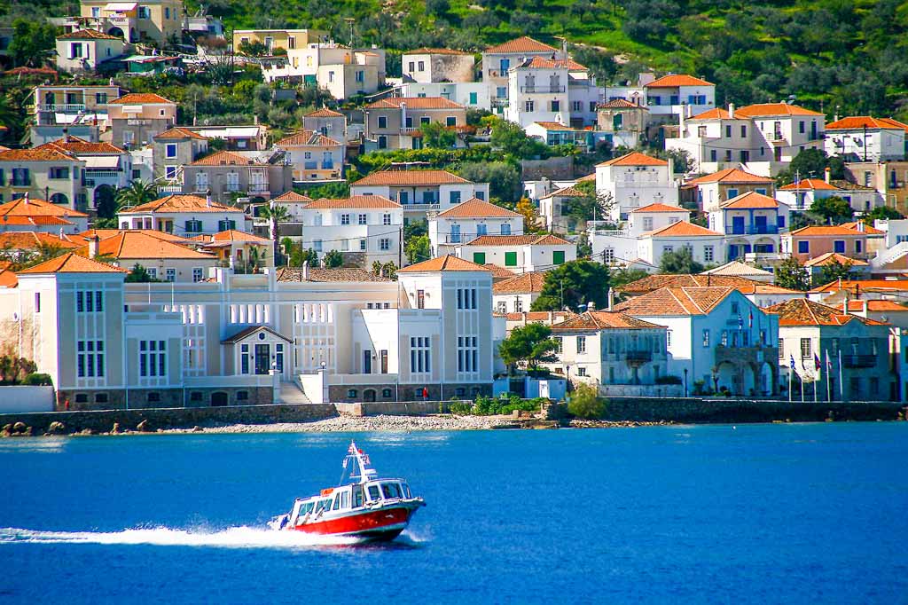 Small red motor boat transfer people to Spetses island, Greece